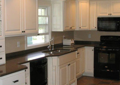 white kitchen cabinets with dark countertops A M Construct Inc. in West Bend, WI